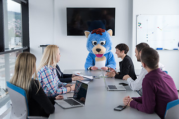 Image showing boss dresed as bear having fun with business people in trendy of