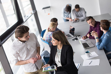 Image showing Two Business People Working With Tablet in office