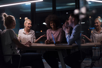 Image showing Multiethnic startup business team in night office