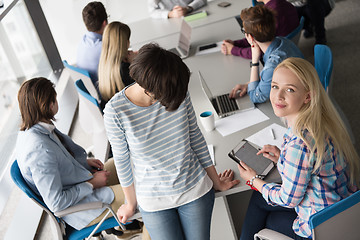 Image showing Pretty Businesswomen Using Tablet In Office Building during conf