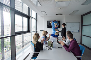 Image showing boss dresed as bear having fun with business people in trendy of