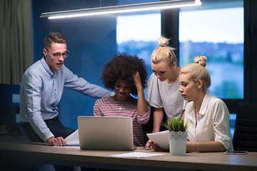 Image showing Multiethnic startup business team in night office