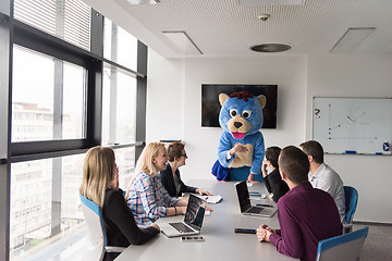 Image showing boss dresed as bear having fun with business people in trendy of