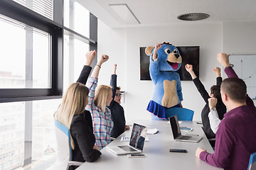 Image showing boss dresed as bear having fun with business people in trendy of