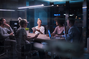 Image showing Multiethnic startup business team in night office