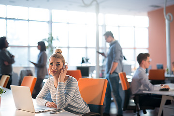 Image showing businesswoman using a laptop in startup office