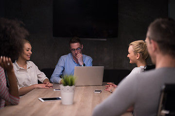 Image showing Multiethnic startup business team in night office