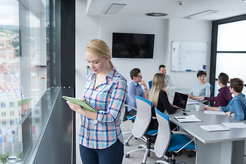 Image showing Pretty Businesswoman Using Tablet In Office Building by window