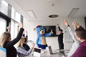 Image showing boss dresed as bear having fun with business people in trendy of