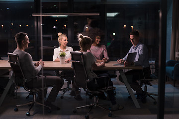 Image showing Multiethnic startup business team in night office