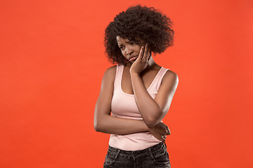 Image showing Beautiful woman looking suprised and bewildered isolated on red