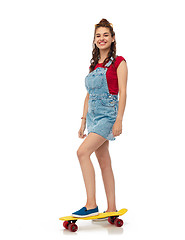 Image showing smiling teenage girl with skateboard over white