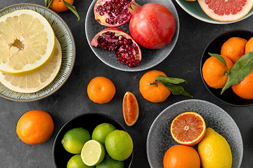 Image showing close up of citrus in bowls fruits on stone table