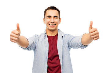 Image showing happy young man showing thumbs up