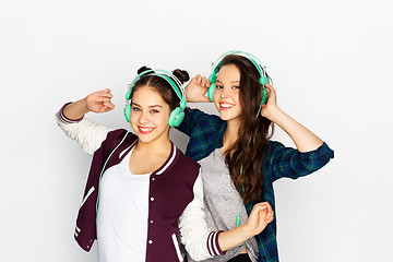 Image showing teenage girls in earphones listening to music