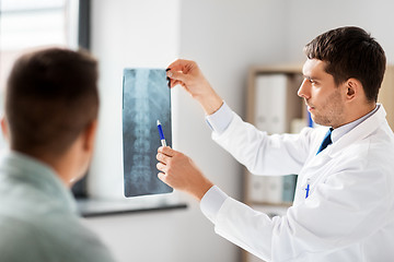 Image showing doctor showing x-ray to patient at hospital