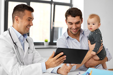 Image showing father with baby and doctor with tablet at clinic