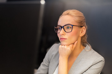 Image showing businesswoman working at computer in night office