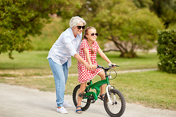 Image showing grandmother and granddaughter with bicycles