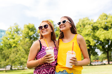 Image showing teenage girls with milk shakes at summer park