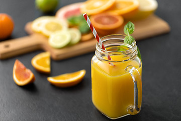 Image showing mason jar glass of fruit juice on slate table top