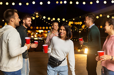 Image showing friends with drinks dancing at rooftop party