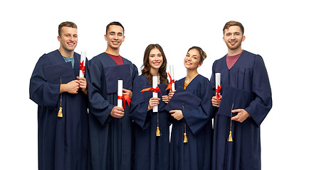 Image showing graduates in mortar boards with diplomas