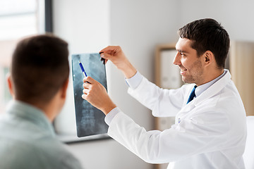 Image showing doctor showing x-ray to patient at hospital