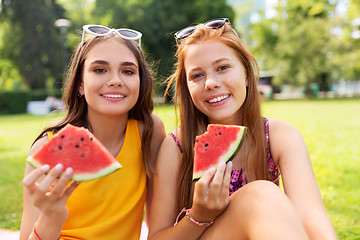 Image showing teenage girls eating watermelon at picnic in park