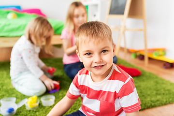 Image showing boy and other children playing at home