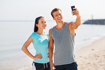 Image showing couple taking selfie by smartphone on beach