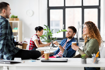 Image showing creative team drinking coffee at office