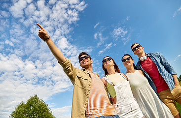 Image showing happy friends looking at something outdoors