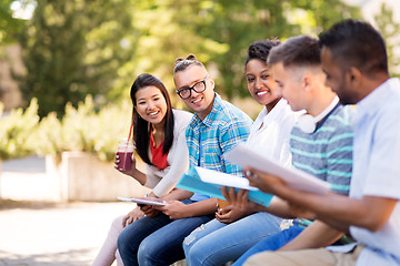 Image showing students with notebook and takeaway drinks