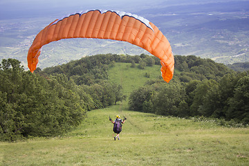 Image showing Paraglider taking off from the edge of the mountain