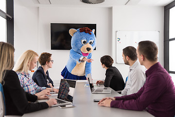 Image showing boss dresed as bear having fun with business people in trendy of