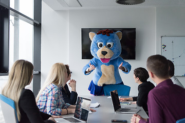 Image showing boss dresed as bear having fun with business people in trendy of