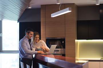 Image showing A young couple is preparing for a job and using a laptop