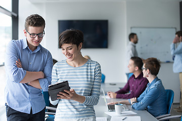 Image showing Two Business People Working With Tablet in office