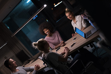 Image showing Multiethnic startup business team in night office