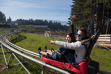 Image showing couple enjoys driving on alpine coaster