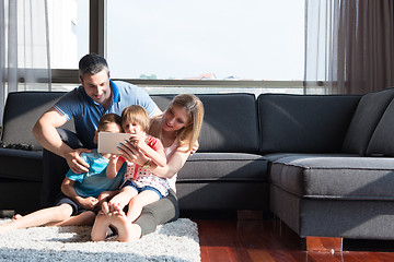 Image showing happy young couple spending time with kids