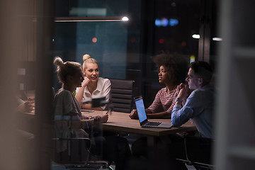 Image showing Multiethnic startup business team in night office