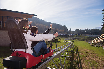 Image showing couple enjoys driving on alpine coaster