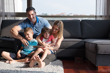 Image showing happy young couple spending time with kids