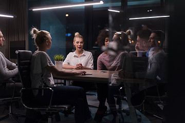 Image showing Multiethnic startup business team in night office