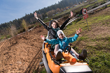 Image showing mother and son enjoys driving on alpine coaster