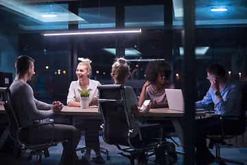 Image showing Multiethnic startup business team in night office