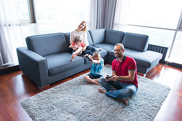 Image showing Happy family playing a video game