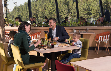 Image showing Young parents enjoying lunch time with their children